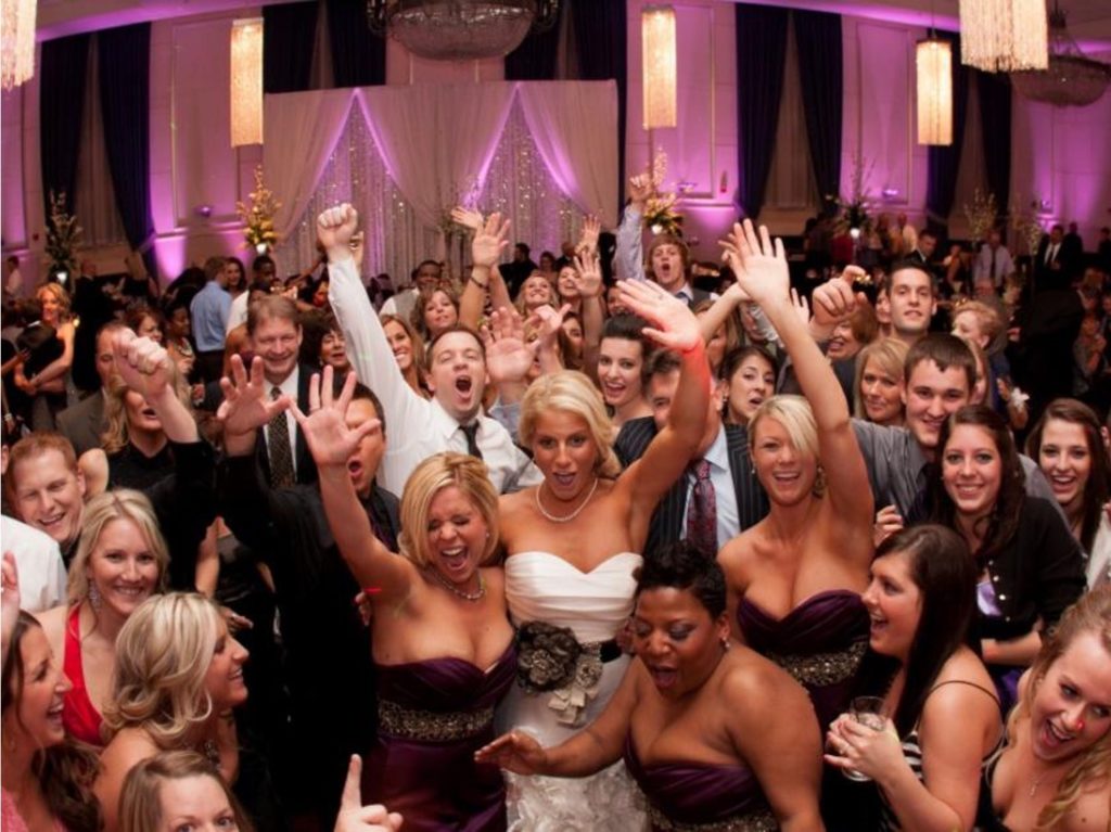 Group photo on dance floor taken by wedding djs