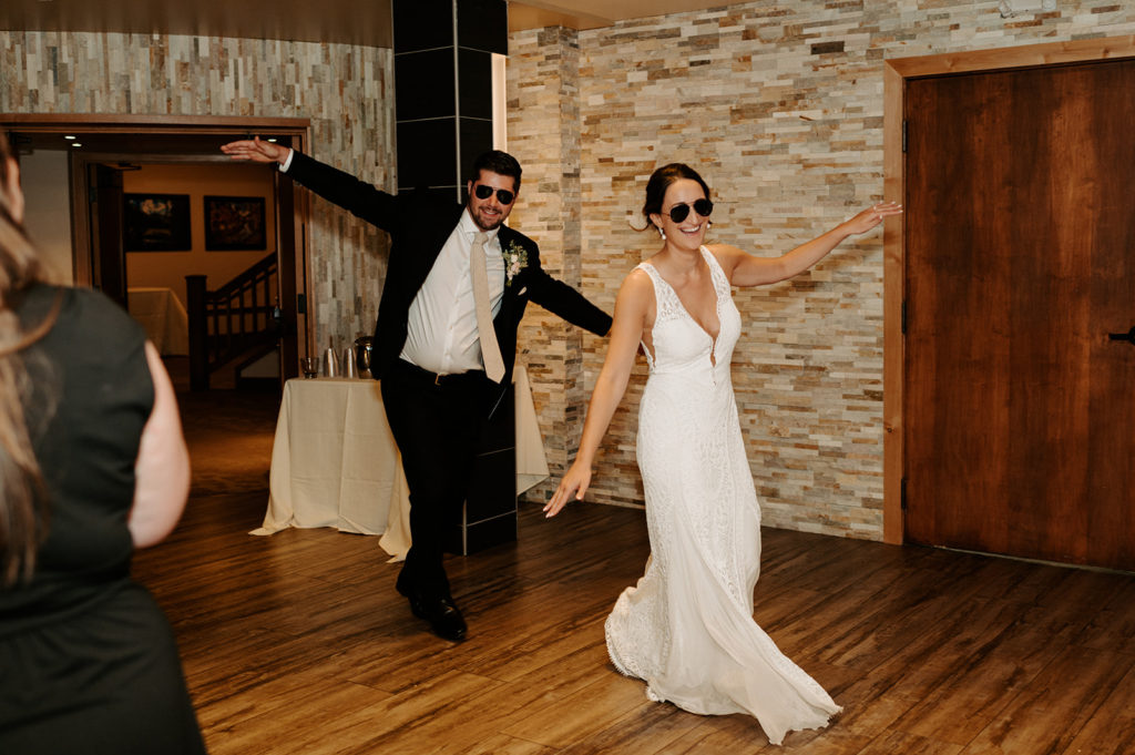 Karly and Mitch "fly" into their wedding reception during introductions.