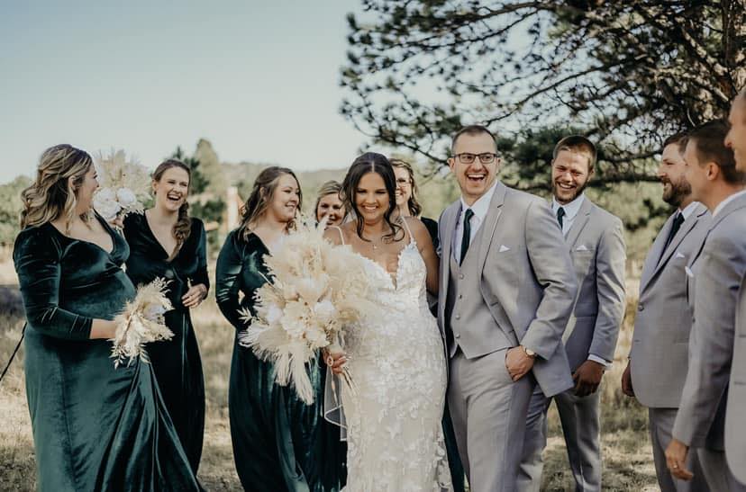 Kate and Matt are surrounded by their wedding party members after getting married.