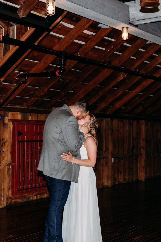 Bride and groom kiss while sharing a private last dance at the end of their wedding night