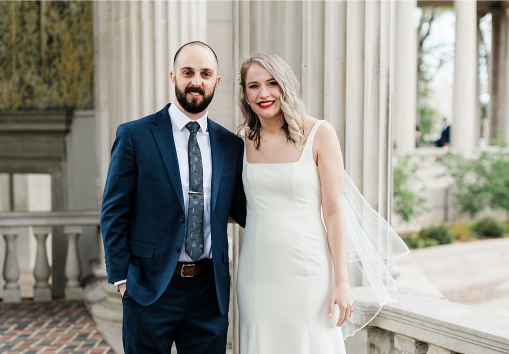 Bride & Groom pose for a picture in Civic Center Park in Denver, CO