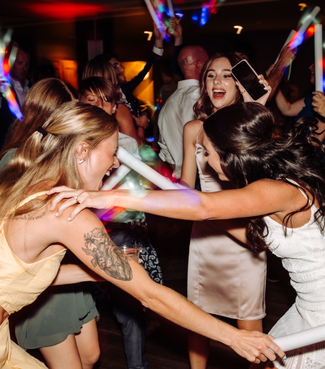 Vibrant wedding party in Denver with the bride shouting out her favorite songs from the skilled Wedding DJ.