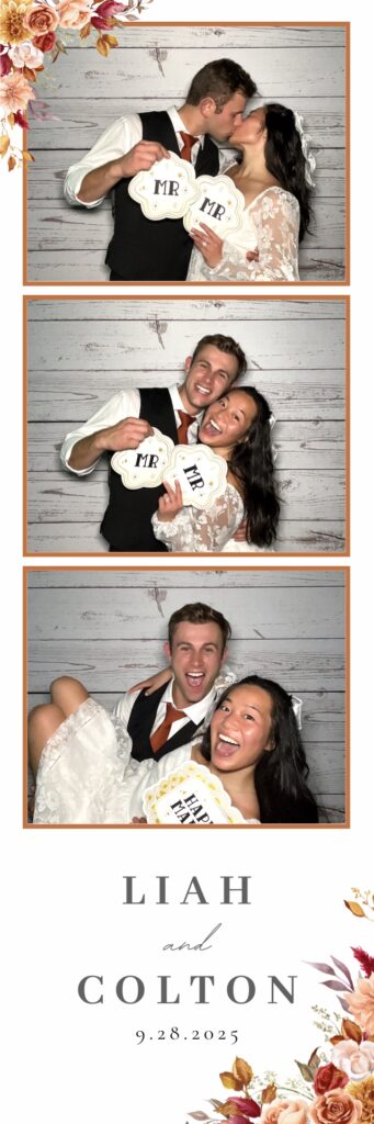 Bride and groom pose for a photo in a rustic themed photo booth rental at Cheyenne Mountain Resort in Colorado Springs.