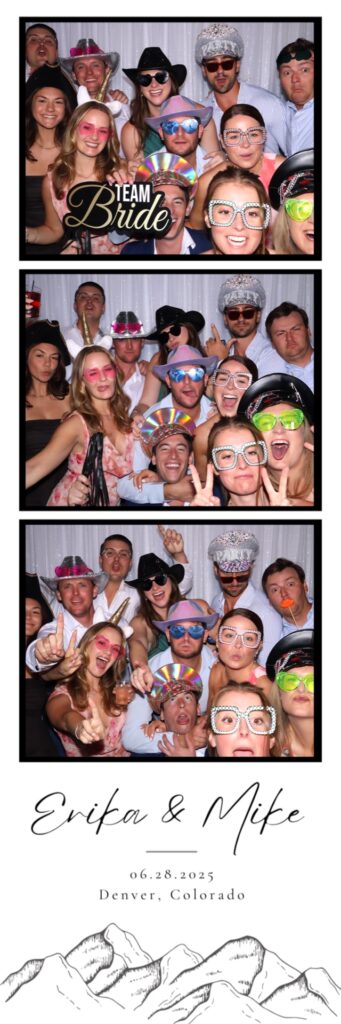 A large group poses for a photo booth rental at a wedding at Upper larimer in Denver Colorado.